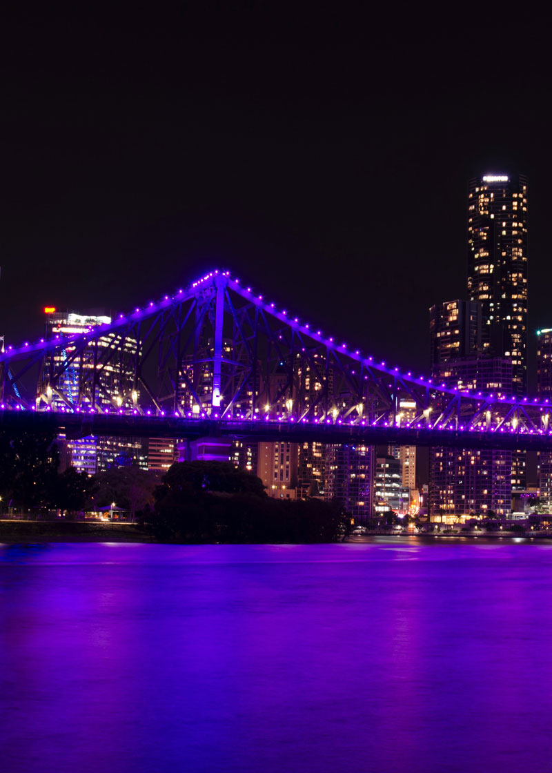 A bridge lit up with purple lights