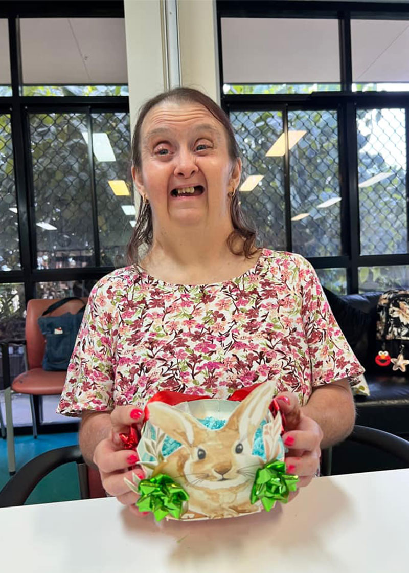 Person holding up their Easter basket and smiling
